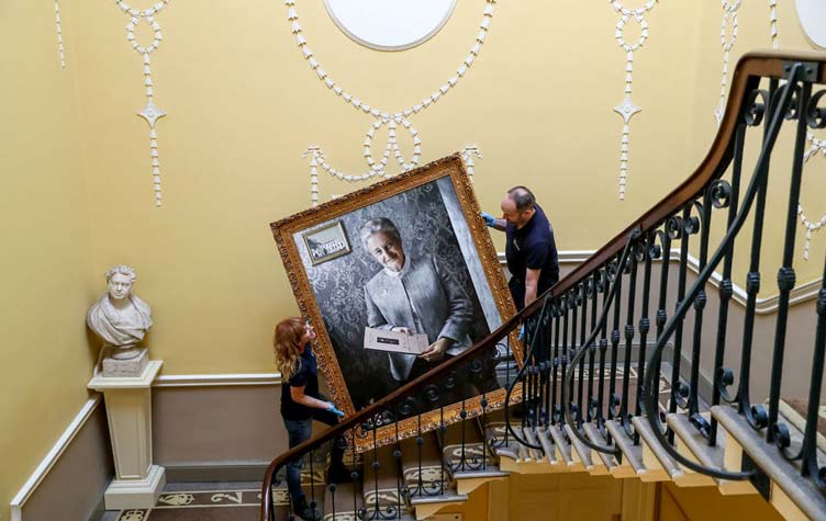 Artwork being moved within historic building