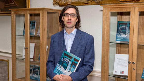 Author holding his publication