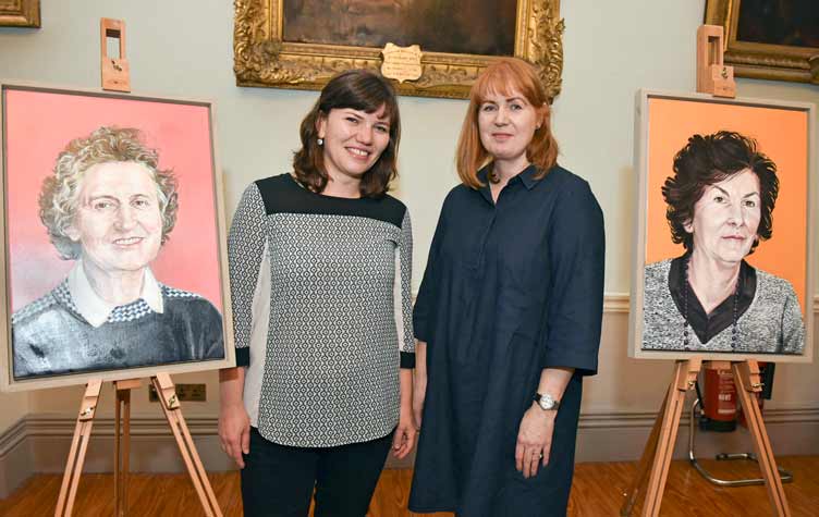 Portrait unveiling showing two artworks and two individuals