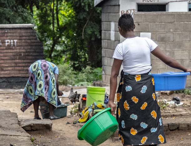 A woman in Africa carrying water in her village