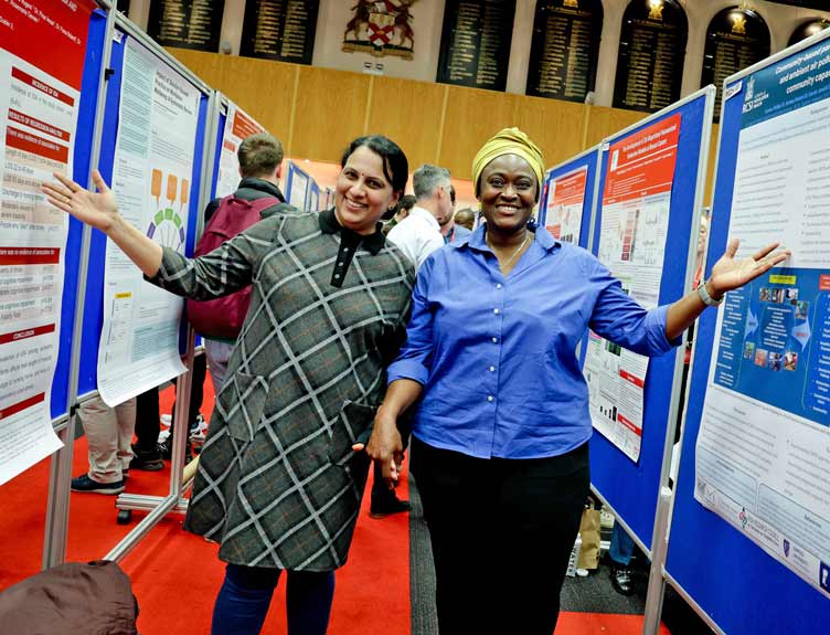 RCSI Research Day 2024 Two ladies smile in front of research findings