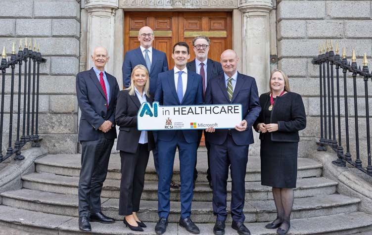Large group pictured in front of historic building at AI in Healthcare launch