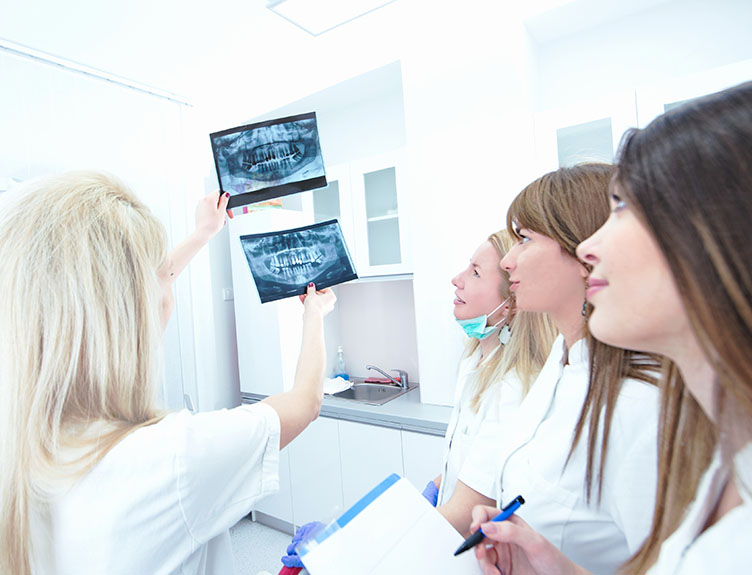 Students examine a dental X-ray.