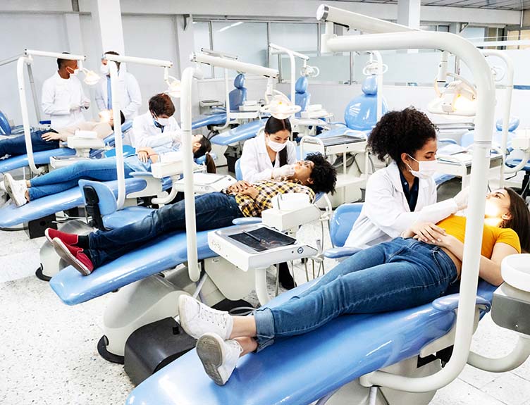 Dentistry students with patients in surgery.