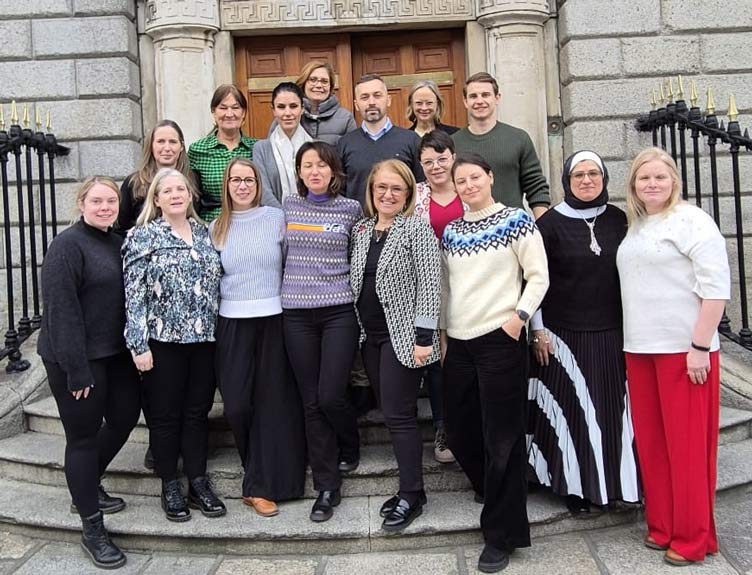 Large group pictured outside old building