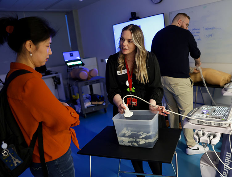 Three people in a medical simulation lab.
