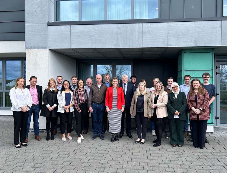 The project group posing outside a building.
