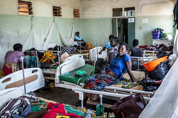 Women and babies on beds in a local clinic, Malawi.