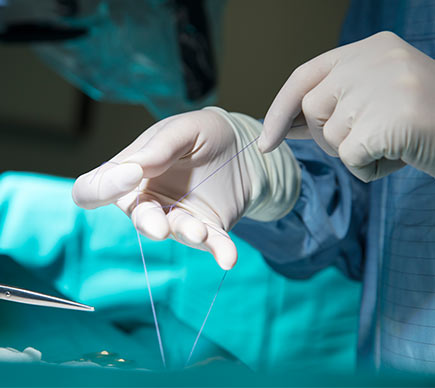 Close-up of a surgeon's hands at the operating table.