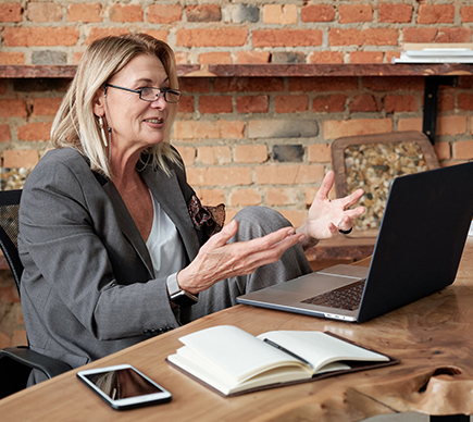 A woman working at a laptop computer.