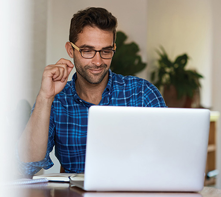 A man working at a laptop computer.