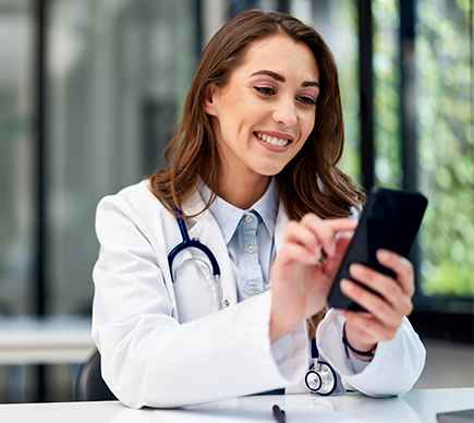 A female doctor using a smartphone.