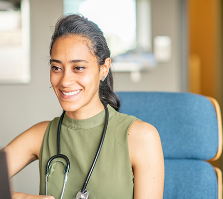 A female doctor working at a desk.