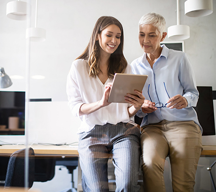 Two people viewing a tablet device.