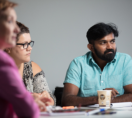 Medical professionals around a seminar table.