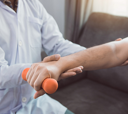 A medical professional helping a patient with an arm injury.