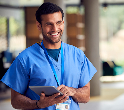 A doctor working on a tablet device.