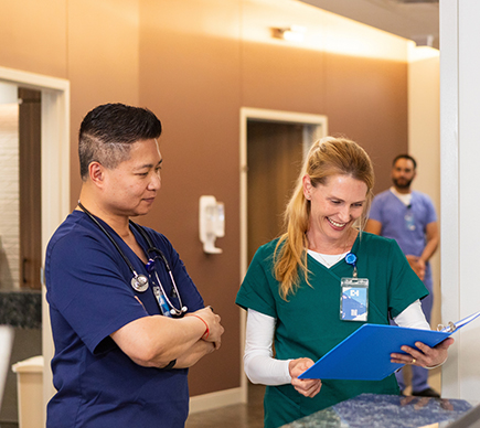 Nurses reviewing a chart.