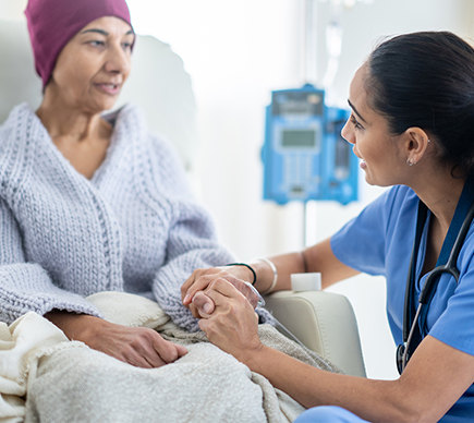 A nurse comforts a cancer patient.