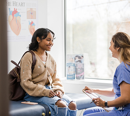 A nurse and patient talking.