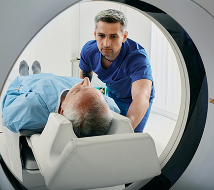 A man being moved into a CT scanner.