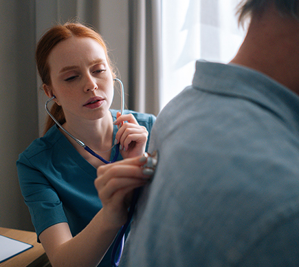 A patient being examined with a stethoscope.