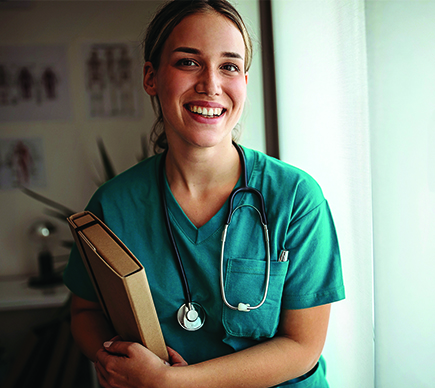 A smiling medical professional with stethoscope and file.