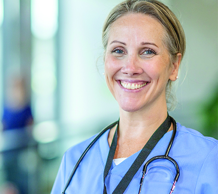 A female medical professional smiling.