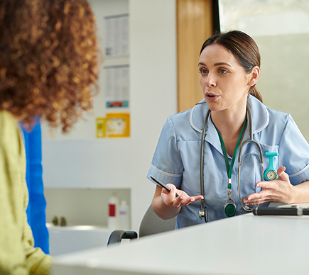 A nurse and a patient talking.