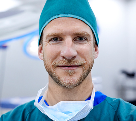 A male medical professional in an operating theatre.