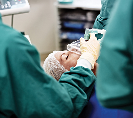 A patient being treated with gas in an operating theatre.