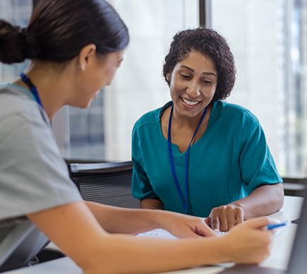 Two nurses conferring.