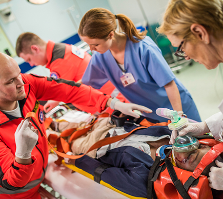 Medical professionals with a patient on a stretcher.