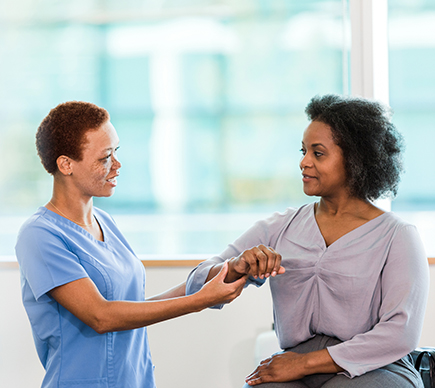 A nurse treating a patient for an upper-limb injury.