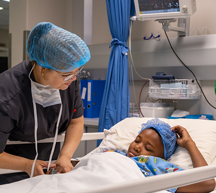 A nurse at a child's bedside.