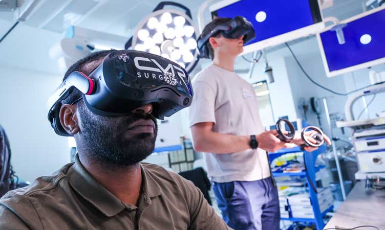 Two individuals wearing headsets during a robotic workshop session