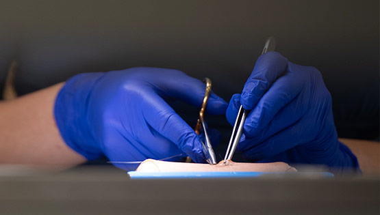 Closeup of surgical gloves suturing