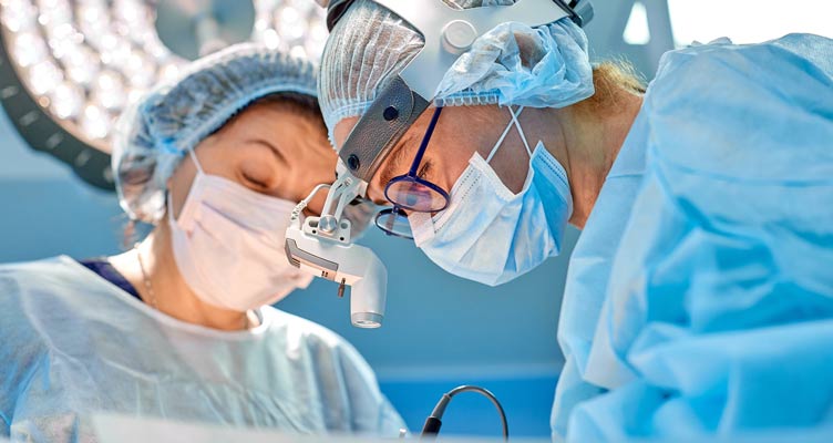 Group of surgeons at operation in operating room at hospital